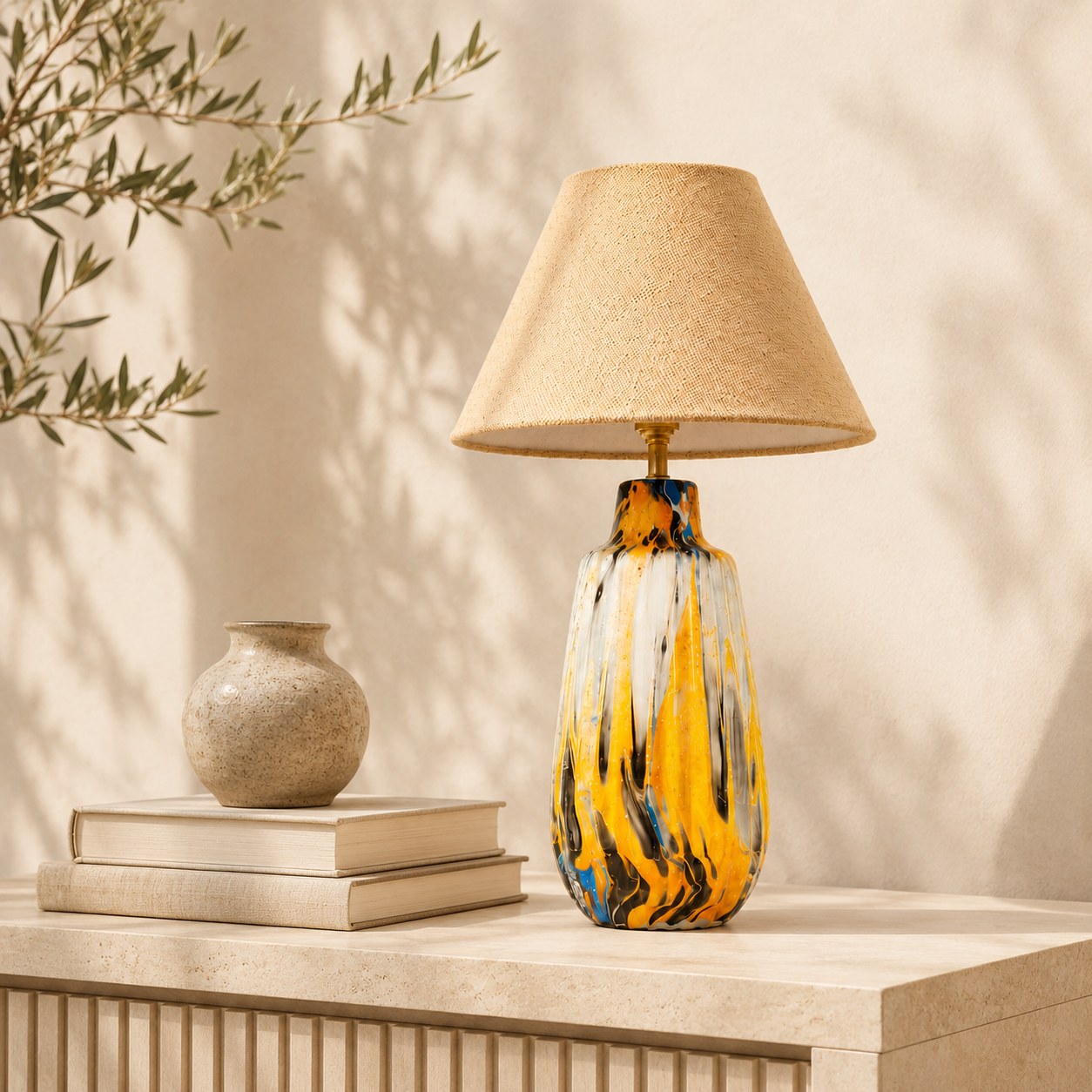 Marbled ceramic table lamp styled on a console with books and ceramic vase for size reference